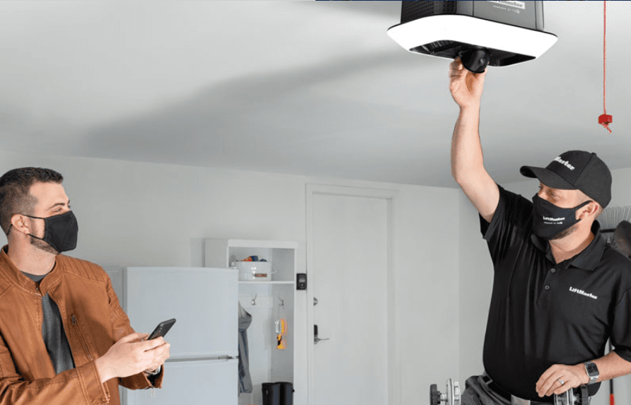 Technician servicing garage door opener